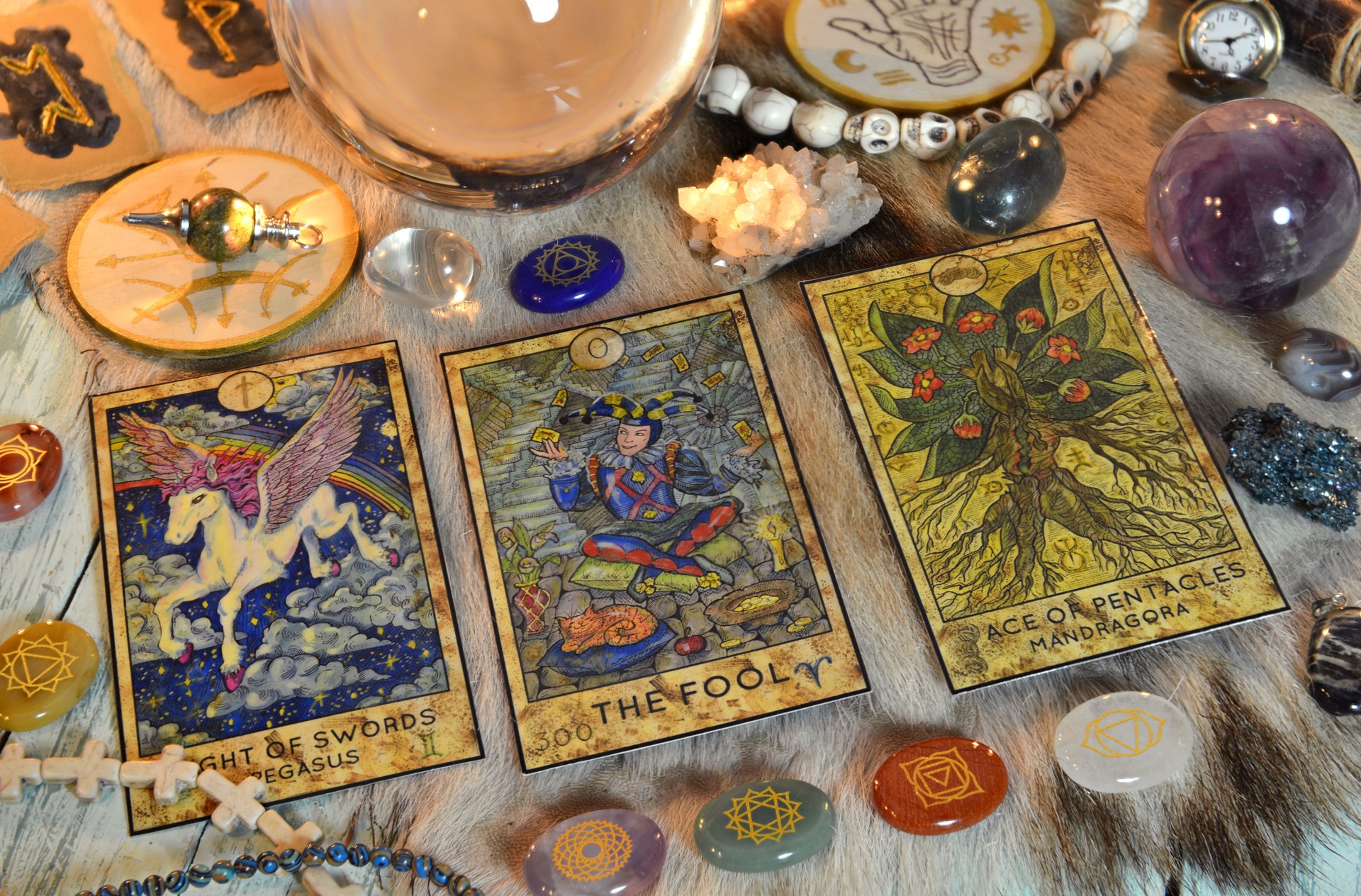Fortune telling ritual with chakras on stones, tarot cards and runes on witch table.