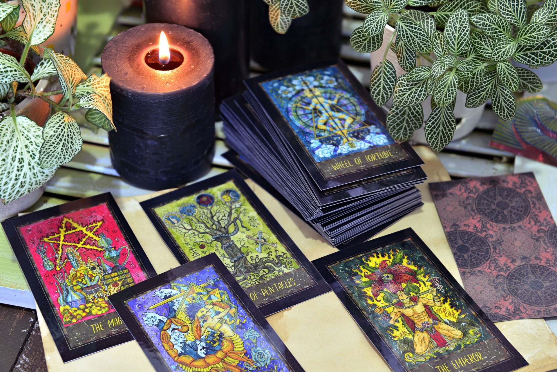 Still life with fantasy tarot cards and black candles.