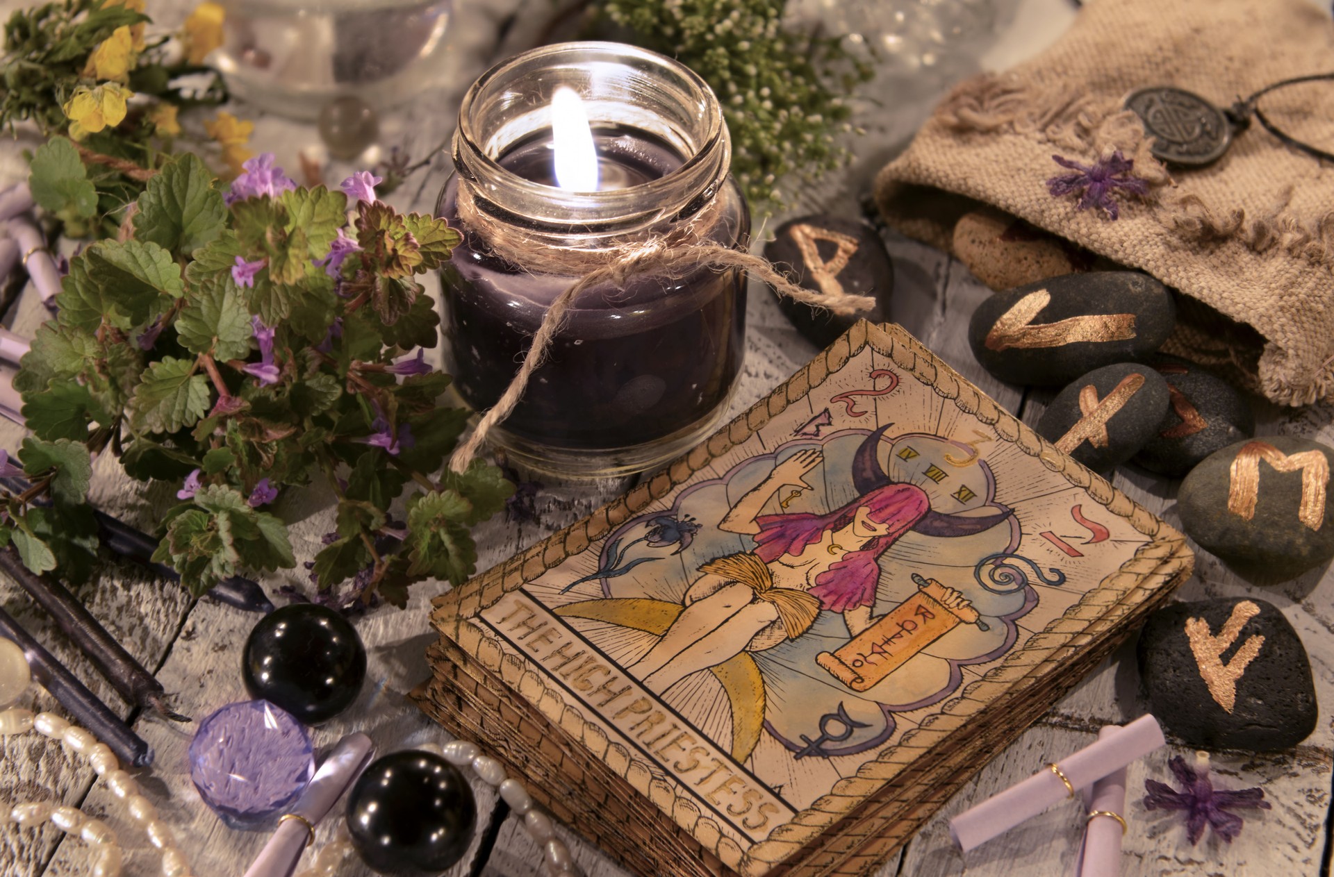 Black candle with the tarot cards and runes
